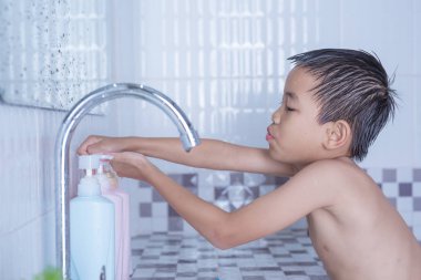 Çocuk dişlerini fırçalıyor ve yüzünü yıkıyor..