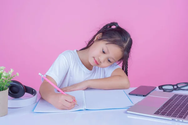 Girls write books on a pink background.