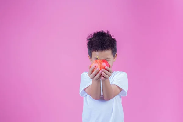 Boy Holds Eats Red Apples Pink Background — Foto de Stock
