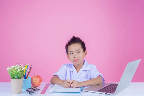 Children write book gestures on a pink background.