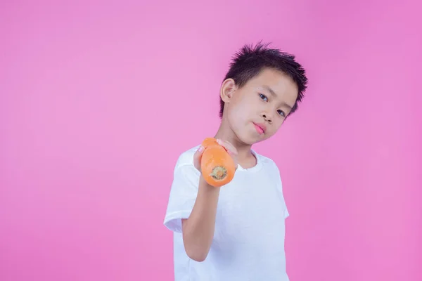 Boy Holding Carrot Pink Background — Stockfoto
