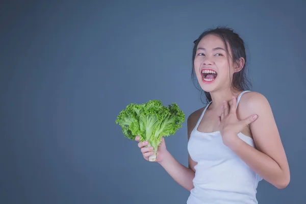 Girl Holds Vegetables Gray Background — Φωτογραφία Αρχείου