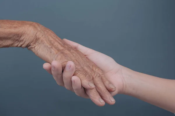 Young Woman Holding Elderly Woman Hand —  Fotos de Stock
