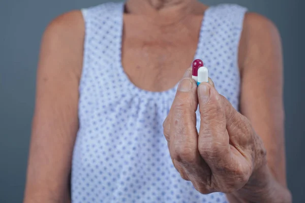Elderly women taking medicine.