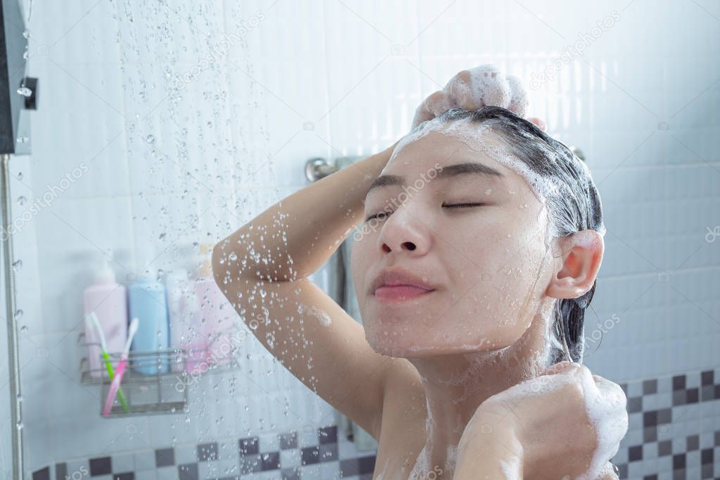 Asian girl standing shower.