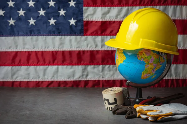 American flag and tools near the helmet Labor day concept.