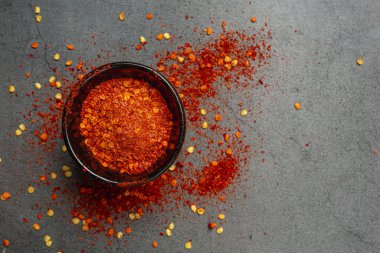 Red chilli paste on a black background.