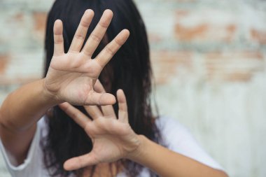 Woman making hand sign stop International day of non violence.