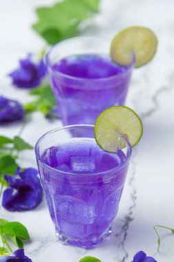 Sağlıklı içecek, limonlu ve limonlu organik mavi bezelye çiçeği çayı..