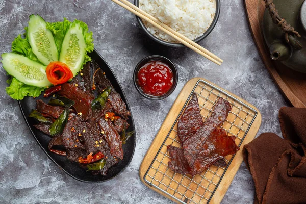 Sun dried beef fried with tomato sauce and steamed rice World food day ideas.