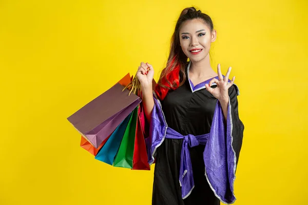 Woman Witch Costume Holding Shopping Bags Yellow Background — Fotografia de Stock