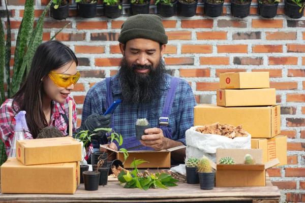 selling plant online; couples happy while taking photo plants by mobile phone