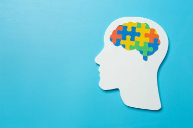 World Mental Health Day; jigsaw brain symbol on blue background.