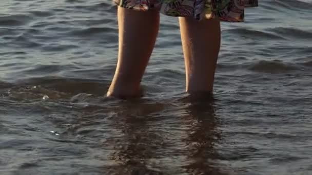 サンディ ビーチ ビーチの砂の上のドレスに入り その軸上を好転させる少女の足 スローモーション — ストック動画