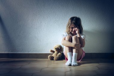 Sad Child Girl Crying Sitting On The Floor clipart