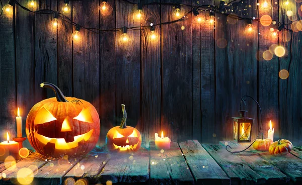 Halloween Jack Lanterns Candles String Lights Wooden Table — стоковое фото