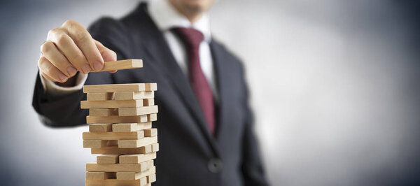 Business Planning And Strategy - Businessman Construct A Tower With Toy Blocks