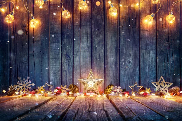 素朴な木製のテーブルの上の星やストリングライトとクリスマスの装飾 — ストック写真