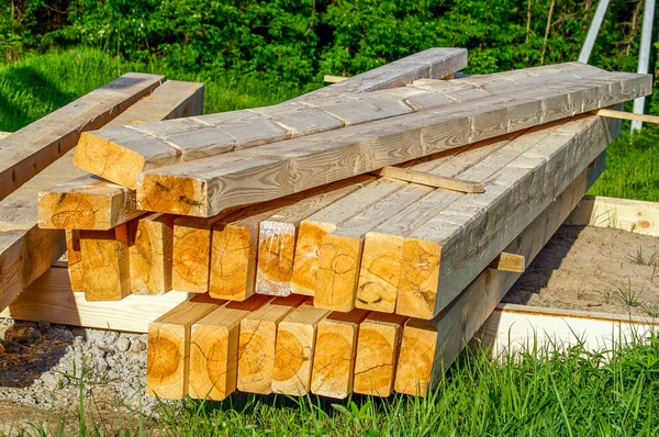       toplu olarak döşenmiş ve inşaat için hazırlanmış işlenmiş ahşap çubuklar                         