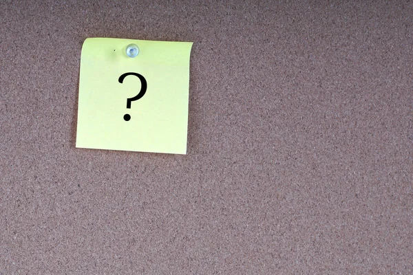 board wall with yellow sticker paper note with question mark