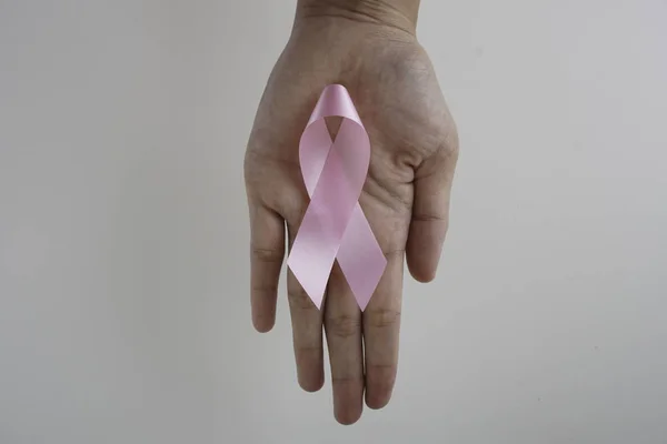 pink aids ribbon in hand