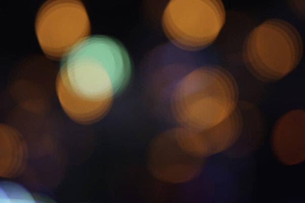 Defocused blurred colorful shiny bokeh lights in night