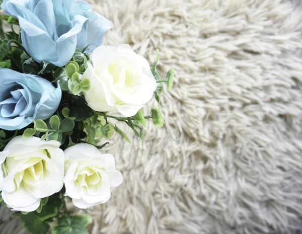 white fluffy rug carpet and roses, flowers on floor with copy space place