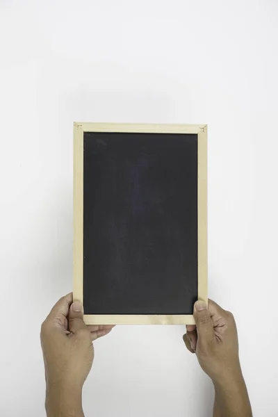 hand holding black board over white background