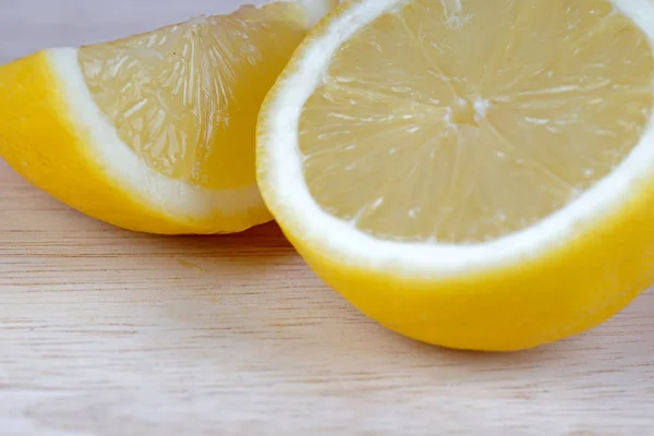 sour yellow lemon slices on white table surface