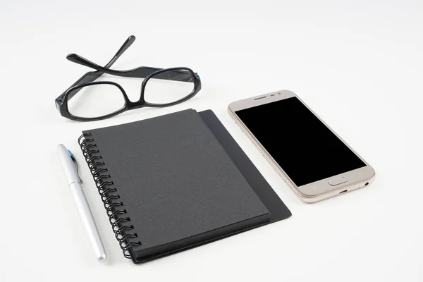 Telefone Celular Óculos Livro Didático Papel Caneta Superfície Branca — Fotografia de Stock