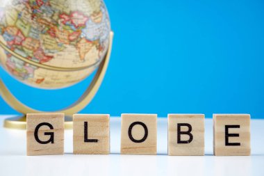 Küre mavi arkaplanda ve Globe 'un tahta yüzeyinde