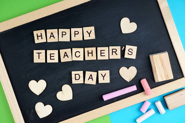 Happy Teacher\'s Day wording on a black board
