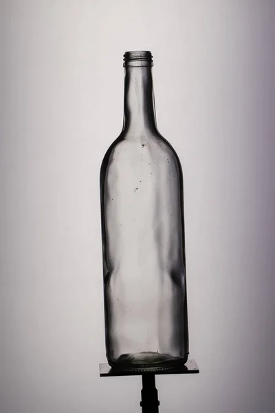 empty wine bottle on grey background
