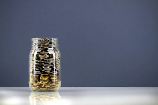saving money coins in jar