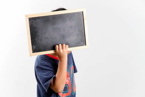 Kid holding an empty blackboard and cover his face