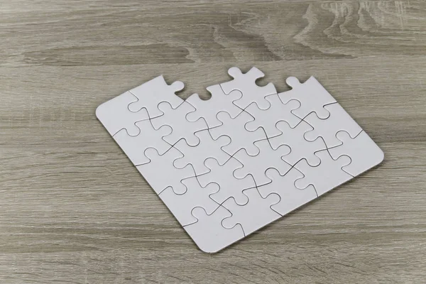 jigsaw puzzle pieces on wooden floor surface