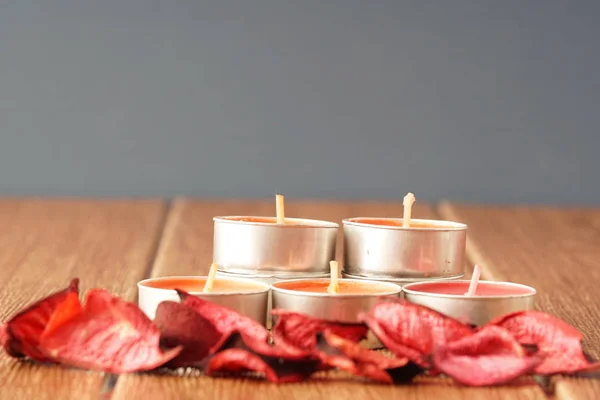 small candles and red roses dry petals, wax tablets candles
