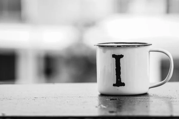 metallic travel white cup on wooden table