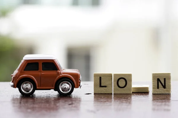 small wooden cubes on table and red small car toy