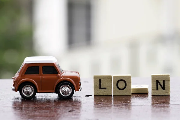 small wooden cubes on table and red small car toy