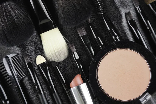 Professional makeup tools. Makeup tools brushes, powder and lipstic. Top view. Flat lay. Selective focus