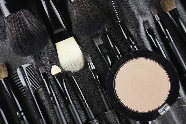 Professional makeup tools. Makeup tools brushes, powder and lipstic. Top view. Flat lay. Selective focus