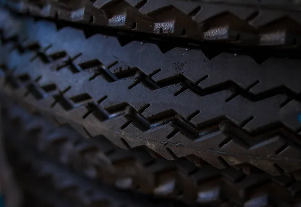 ycling background. Tire stack. ycling tyre protector close up. Black rubber tire. Brand new  tires. Close up black tyre profile. tires in a row