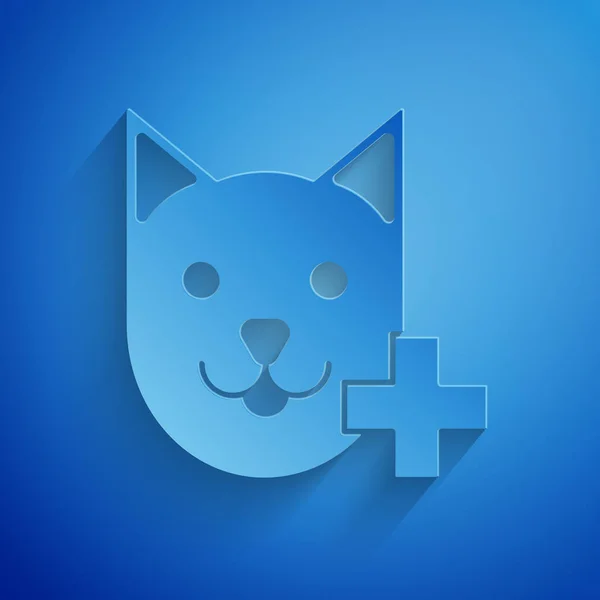 Corte de papel icono del símbolo de la clínica veterinaria aislado sobre fondo azul. Cruza con la atención veterinaria del gato. Signo de primeros auxilios. Estilo de arte de papel. Ilustración vectorial — Vector de stock