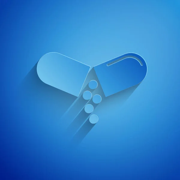 Papier gesneden geneeskunde pil of Tablet pictogram geïsoleerd op blauwe achtergrond. Capsule pil en drug teken. Apotheek ontwerp. Papier kunststijl. Vector illustratie — Stockvector