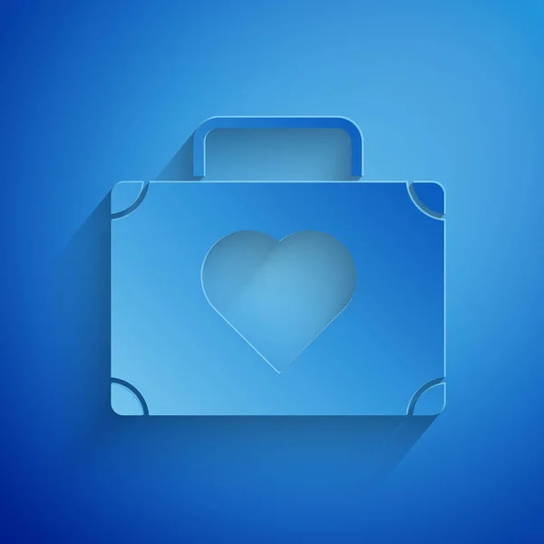 Paper cut Suitcase for travel with heart icon isolated on blue background. Honeymoon symbol. Traveling baggage sign. Travel luggage icon. Paper art style. Vector Illustration — Stock Vector