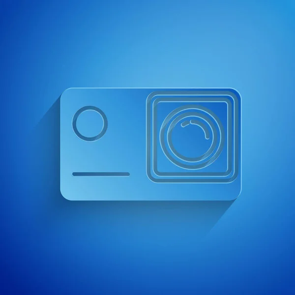 Paper cut Action extreme camera icon isolated on blue background. Video camera equipment for filming extreme sports. Paper art style. Vector Illustration