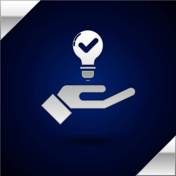 Silver Light bulb in hand icon isolated on dark blue background. Concept of idea. Vector Illustration — Stock Vector