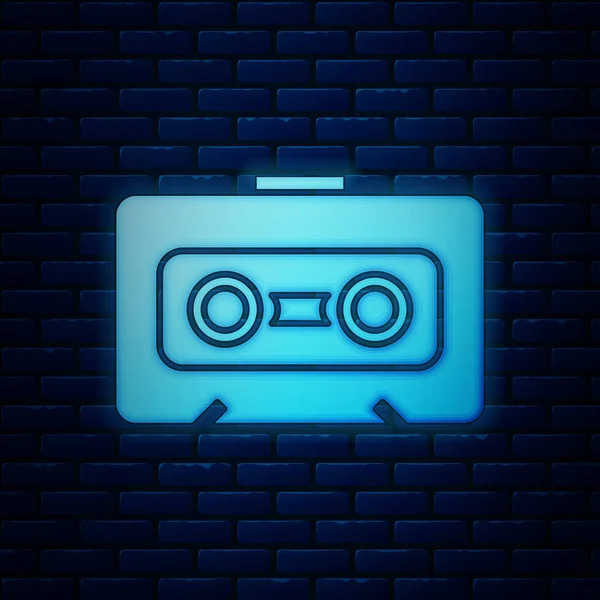 Ragyogó neon Retro audio kazetta ikon elszigetelt téglafal háttér. Vektorillusztráció — Stock Vector