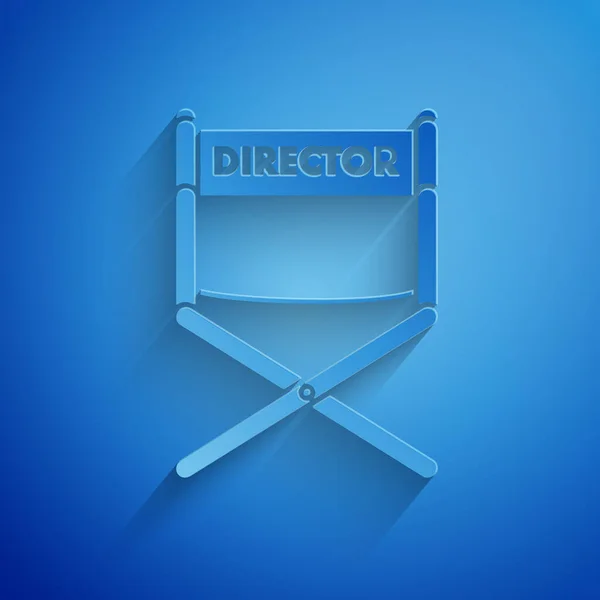 Paper cut Director movie chair icon isolated on blue background. Film industry. Paper art style. Vector Illustration — ストックベクタ